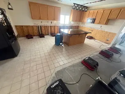 Drying equipment staged across a tile kitchen floor after a water loss in Palmdale