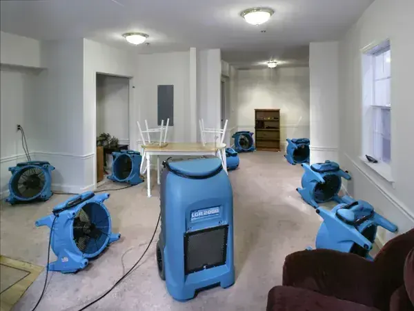 Air movers and an LGR dehumidifier drying an open Palmdale room to the S500 goal