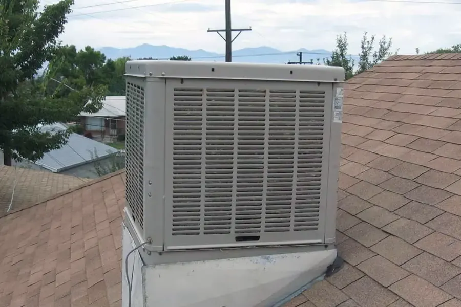 Rooftop evaporative swamp cooler on a shingle roof of an Antelope Valley home